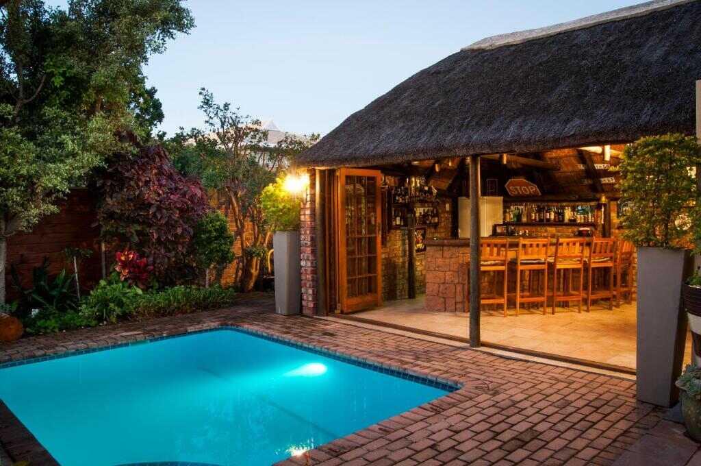 Pool and garden lit up in the evening